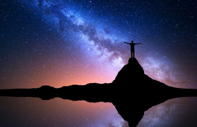 Milky Way and man on the rock. Galaxy, Universe