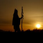 silhouette of native american shaman with pikestaff