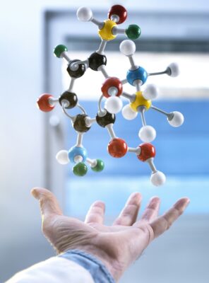 Hand and a floating molecular model, gravity