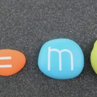 Science physics formula e=mc2, Theory of relativity composed with colored and carved stones