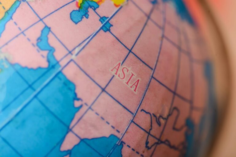 the Asia map on a globe beckons travelers to chart their journeys