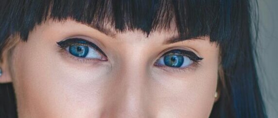 Photo of Woman With Blue Eyes and Black Hair