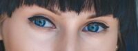 Photo of Woman With Blue Eyes and Black Hair